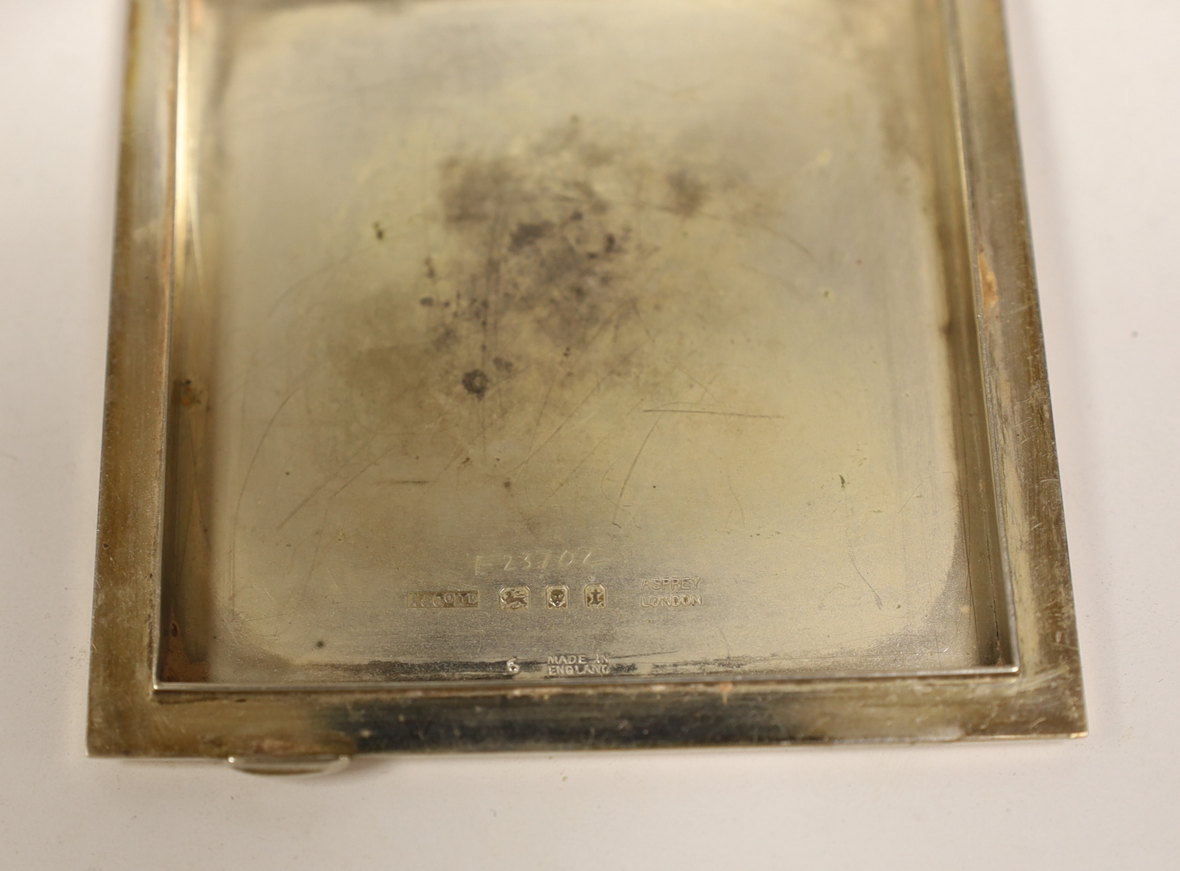 A George V engine turned silver and yellow metal compact, by Asprey & Co, with marcasite set initials 'MG', 72mm in original Asprey & Co fitted case (lacking powder puff).